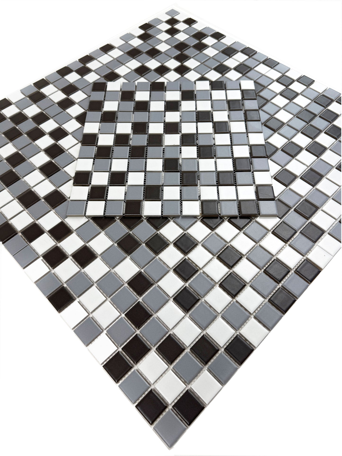 Black, white, and gray mosaic tiles on a white background