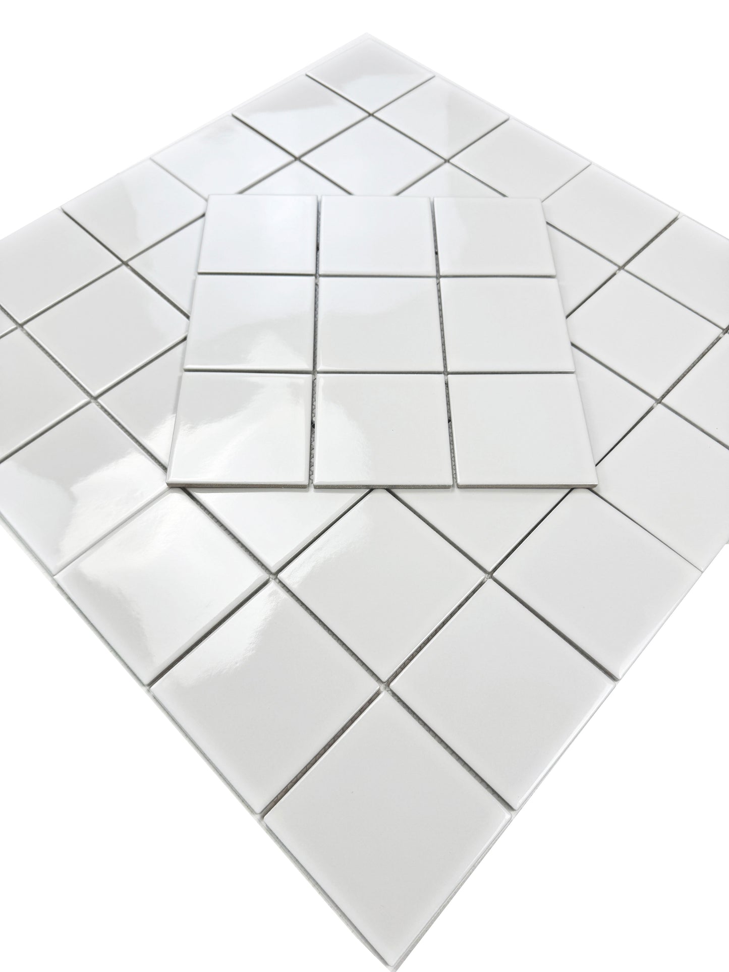 White porcelain tiles arranged in a geometric pattern on a white background