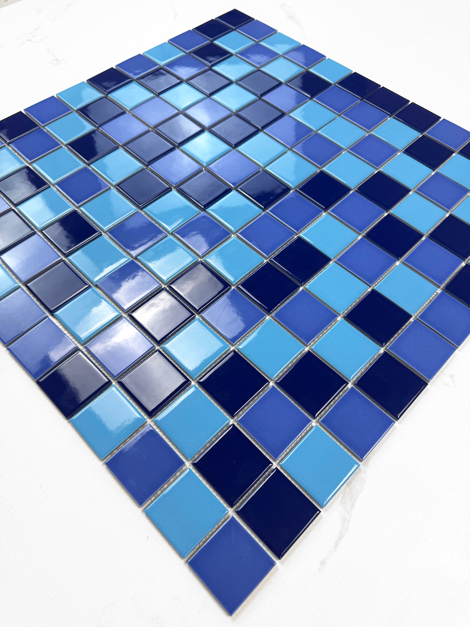 Mosaic tile pattern with blue squares on a white background