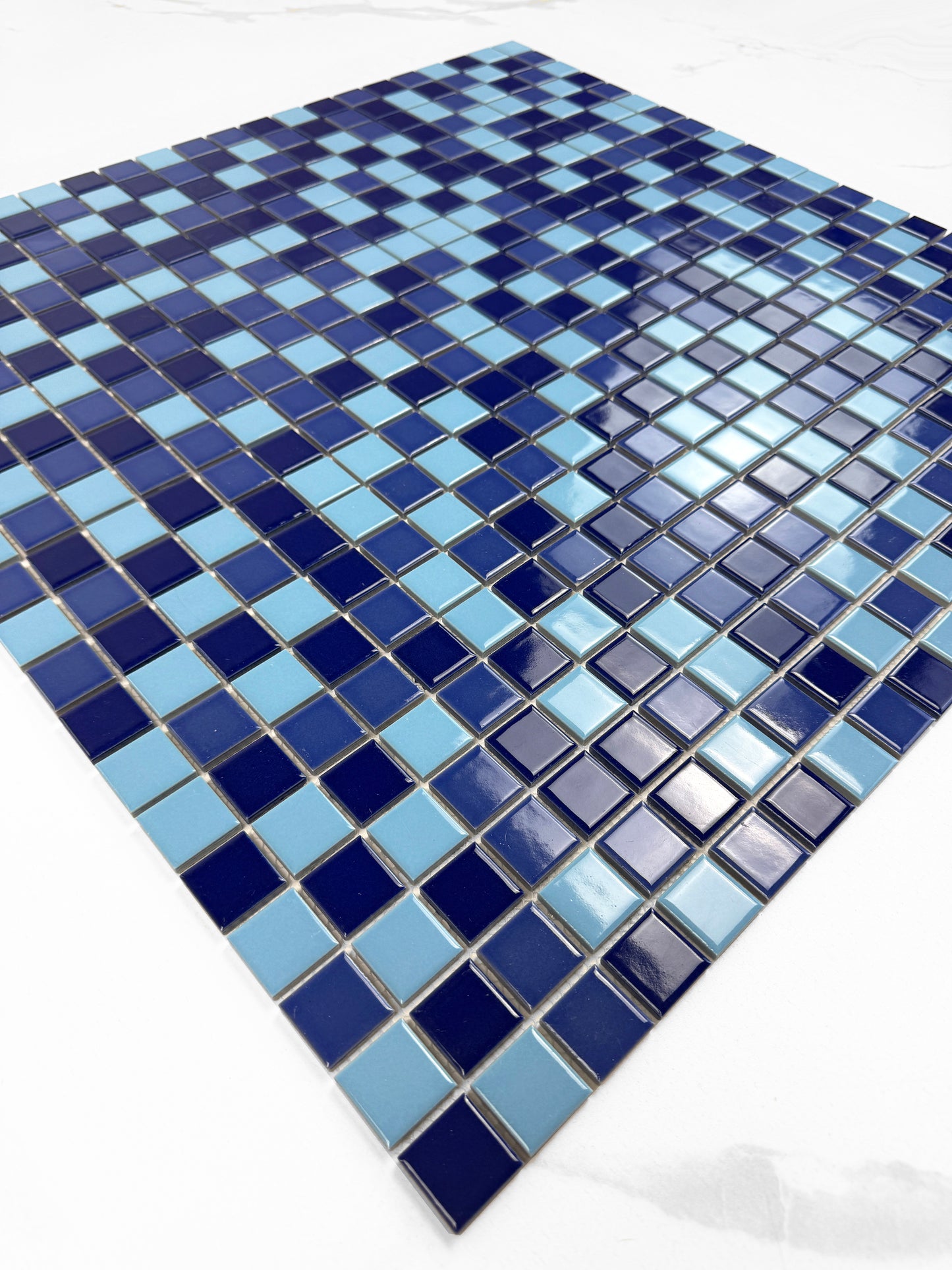 Blue and gray mosaic tile pattern on a white background