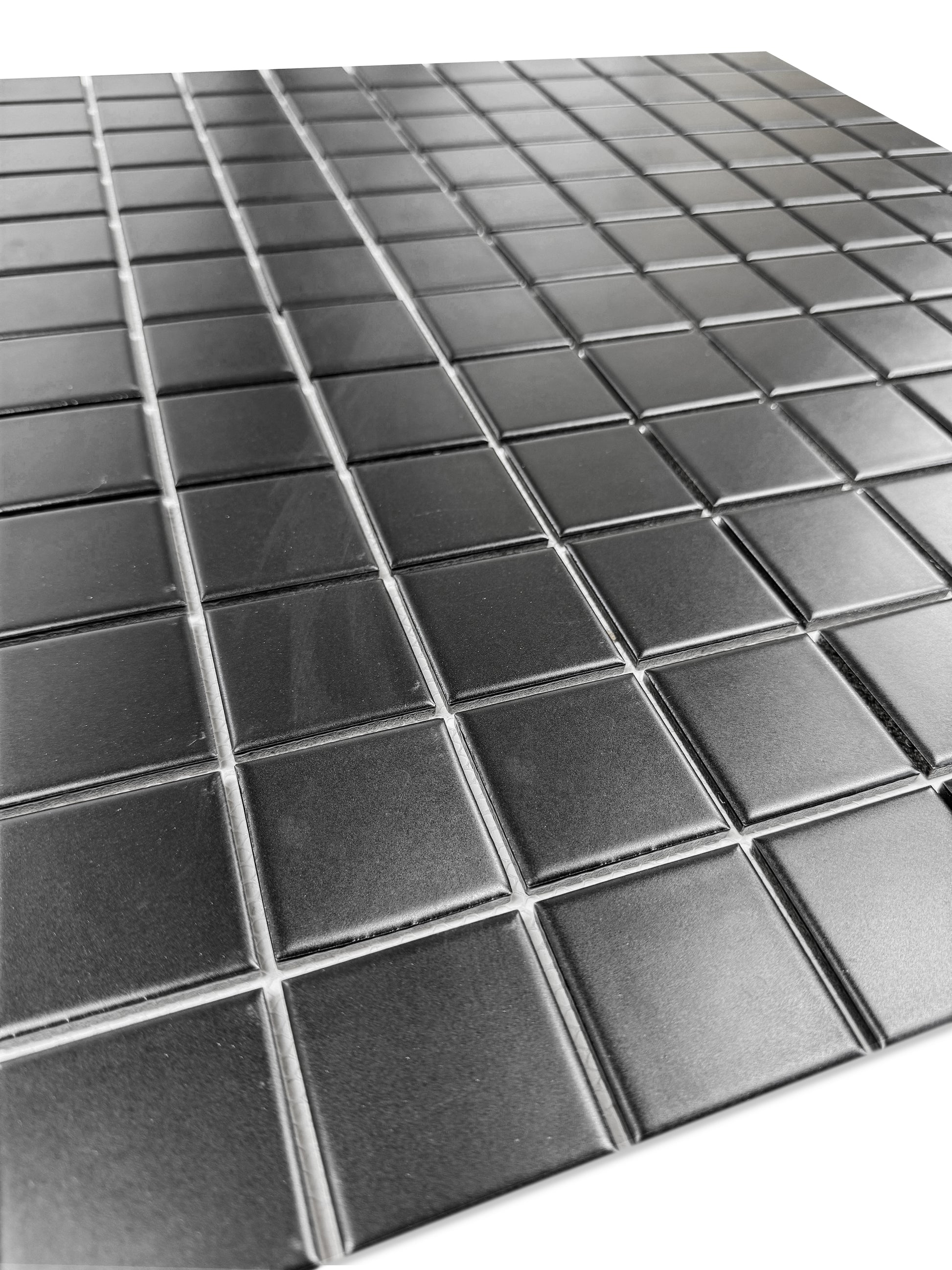 Close-up of a black mosaic square tiles on a white background