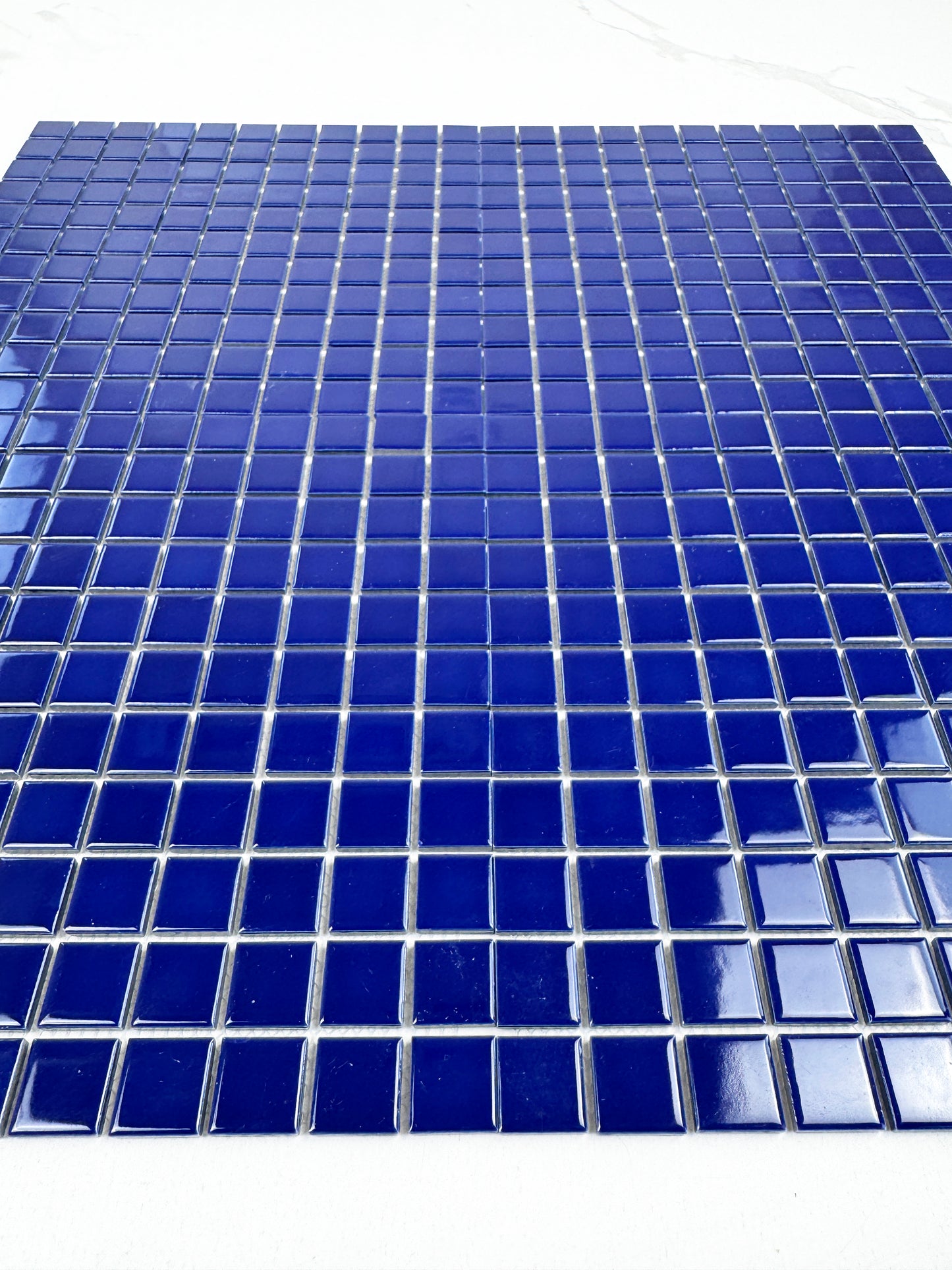 Blue mosaic tiles on a white background