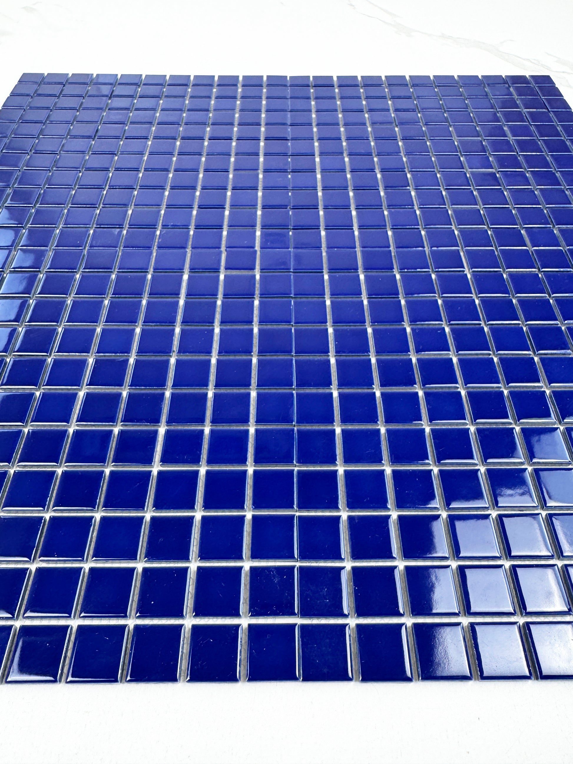 Blue mosaic tiles on a white background