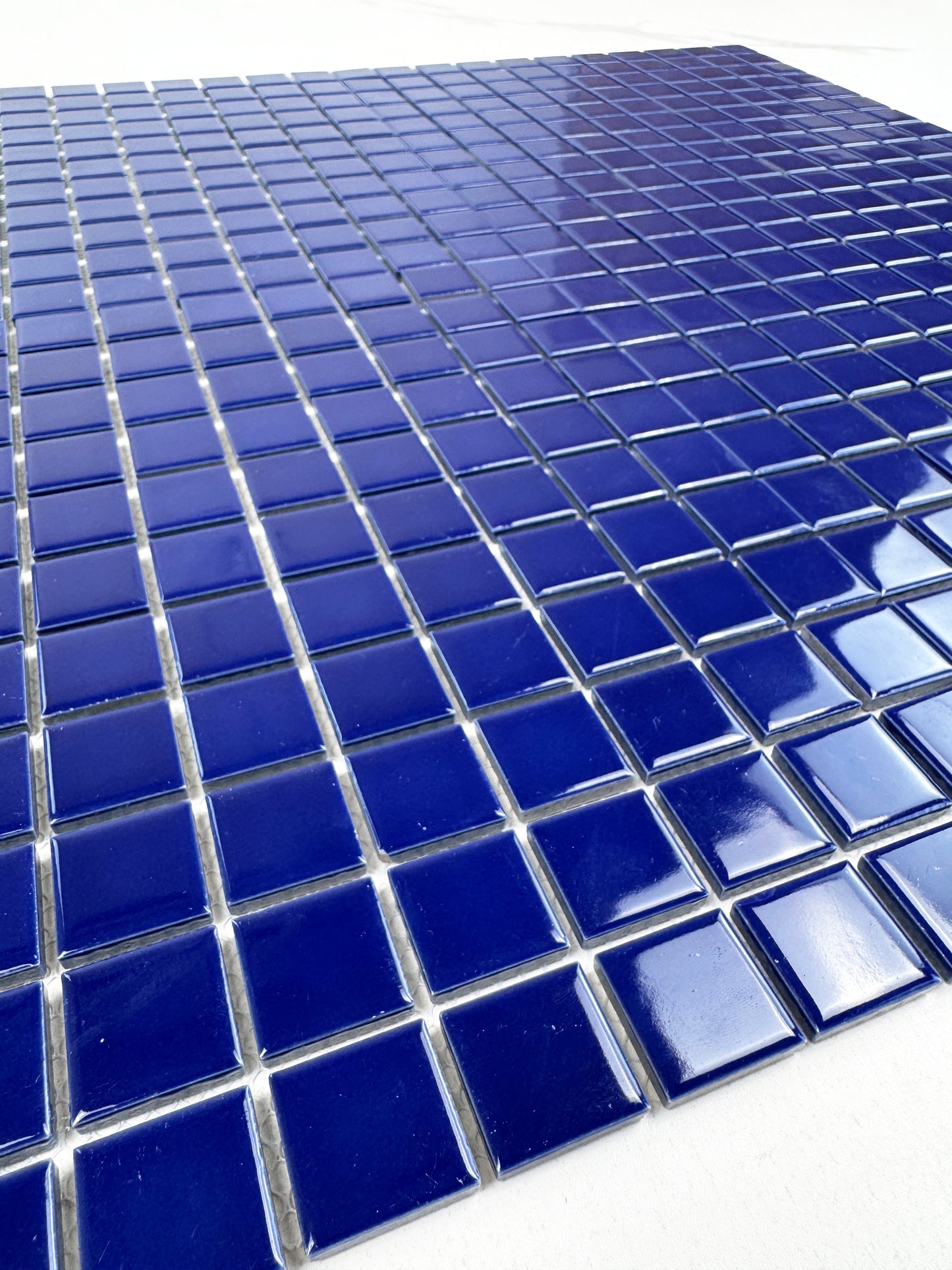 Close-up of blue mosaic tiles on a white background
