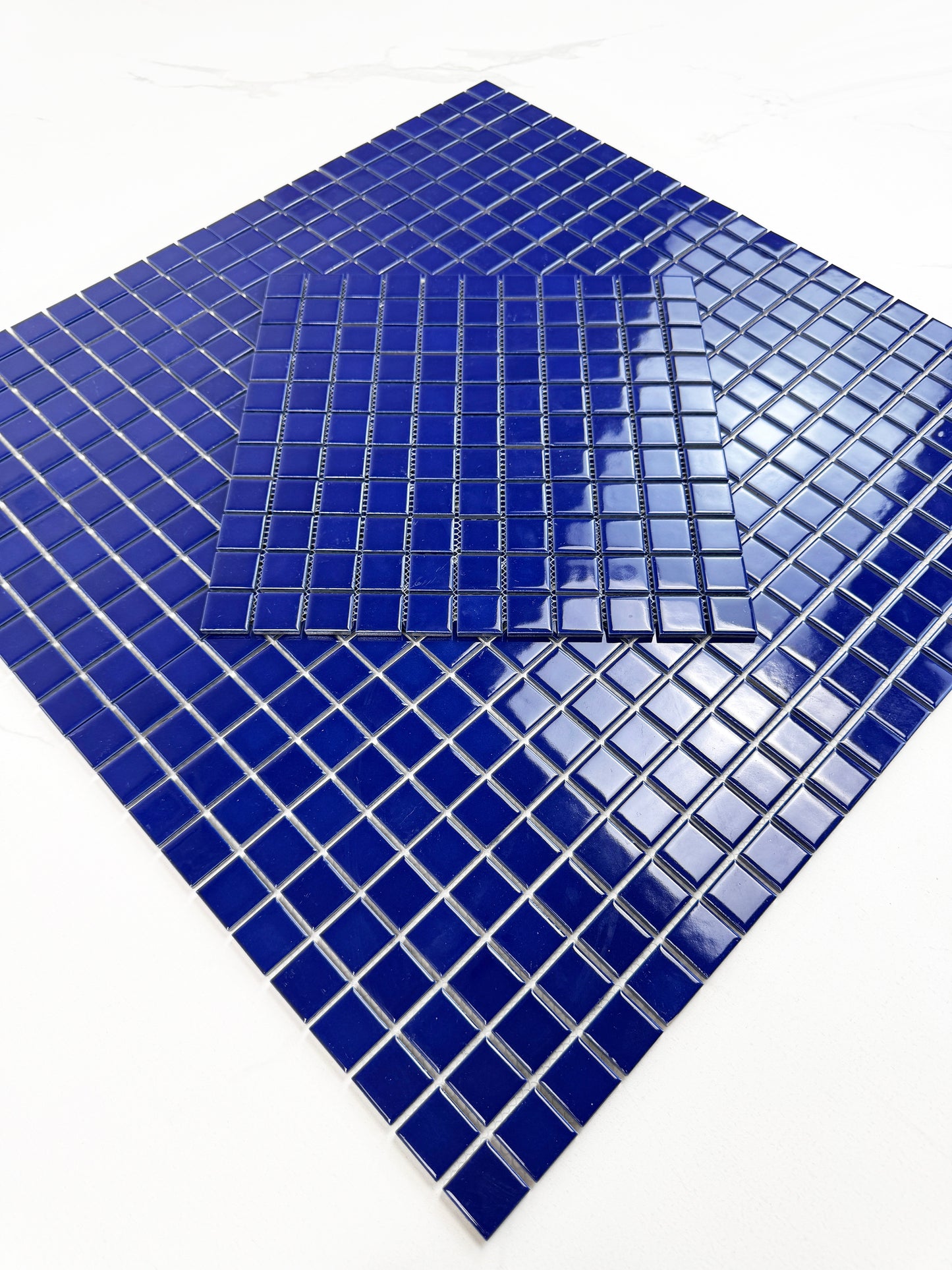 Blue mosaic tiles on a white background