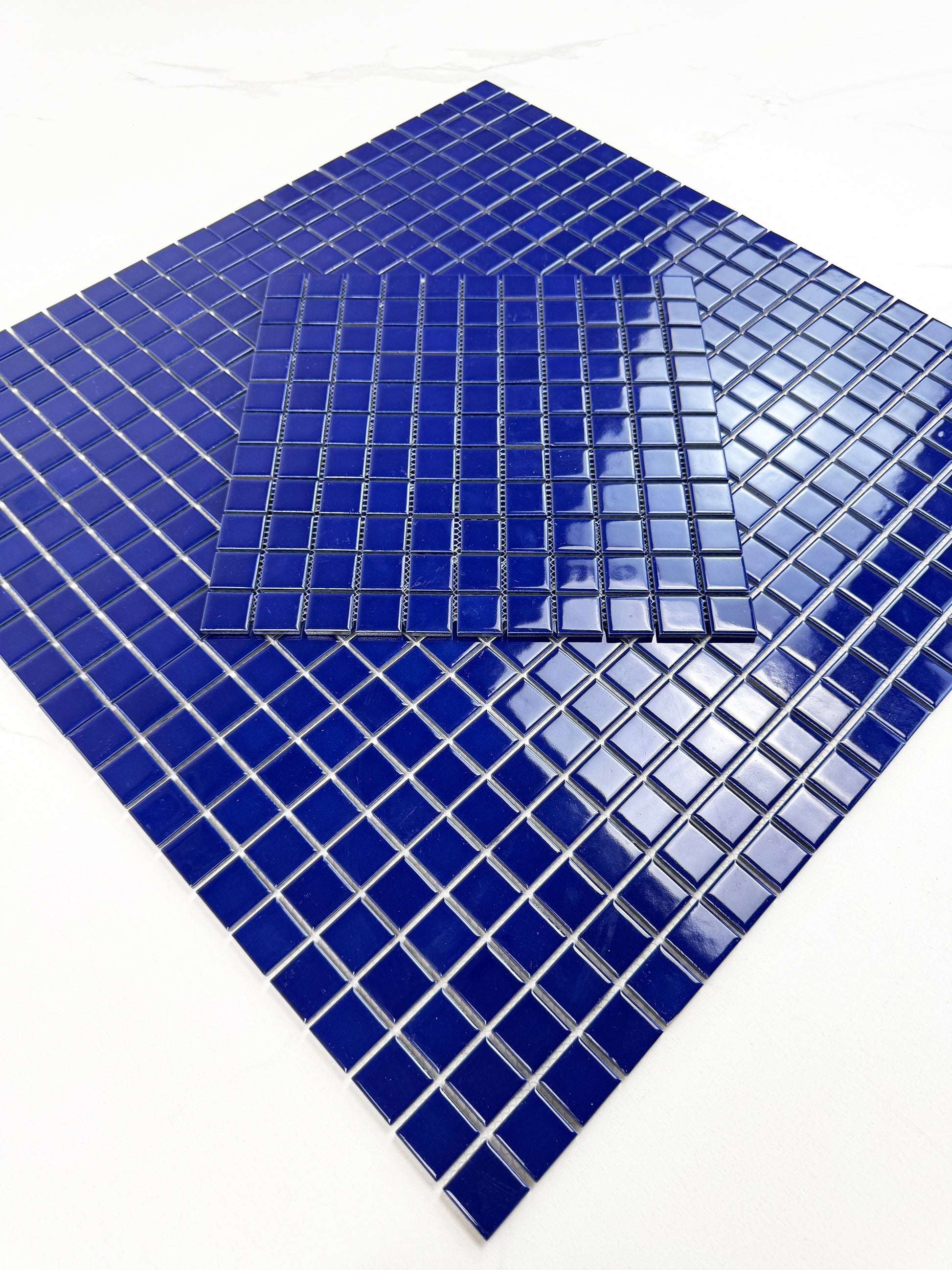 Blue mosaic tiles on a white background