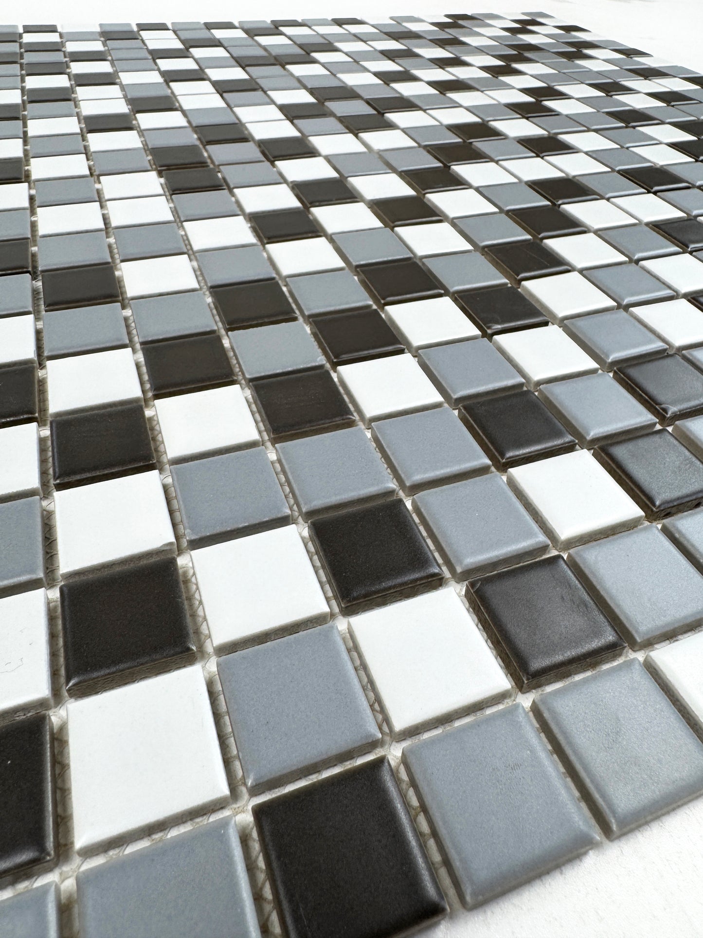 Mosaic tile pattern with black, white, and gray tiles