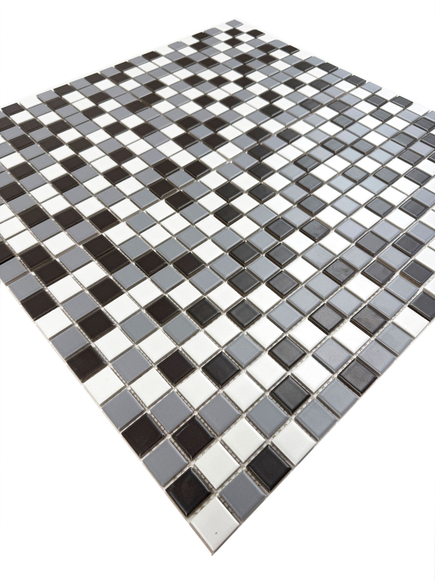 Mosaic tile pattern with black, white, and gray squares on a white background