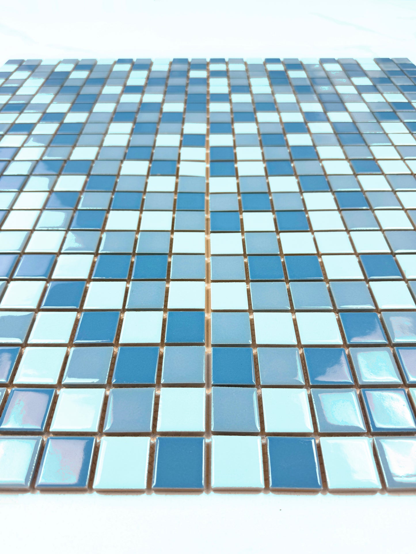 Mosaic pattern of blue tiles on a white background
