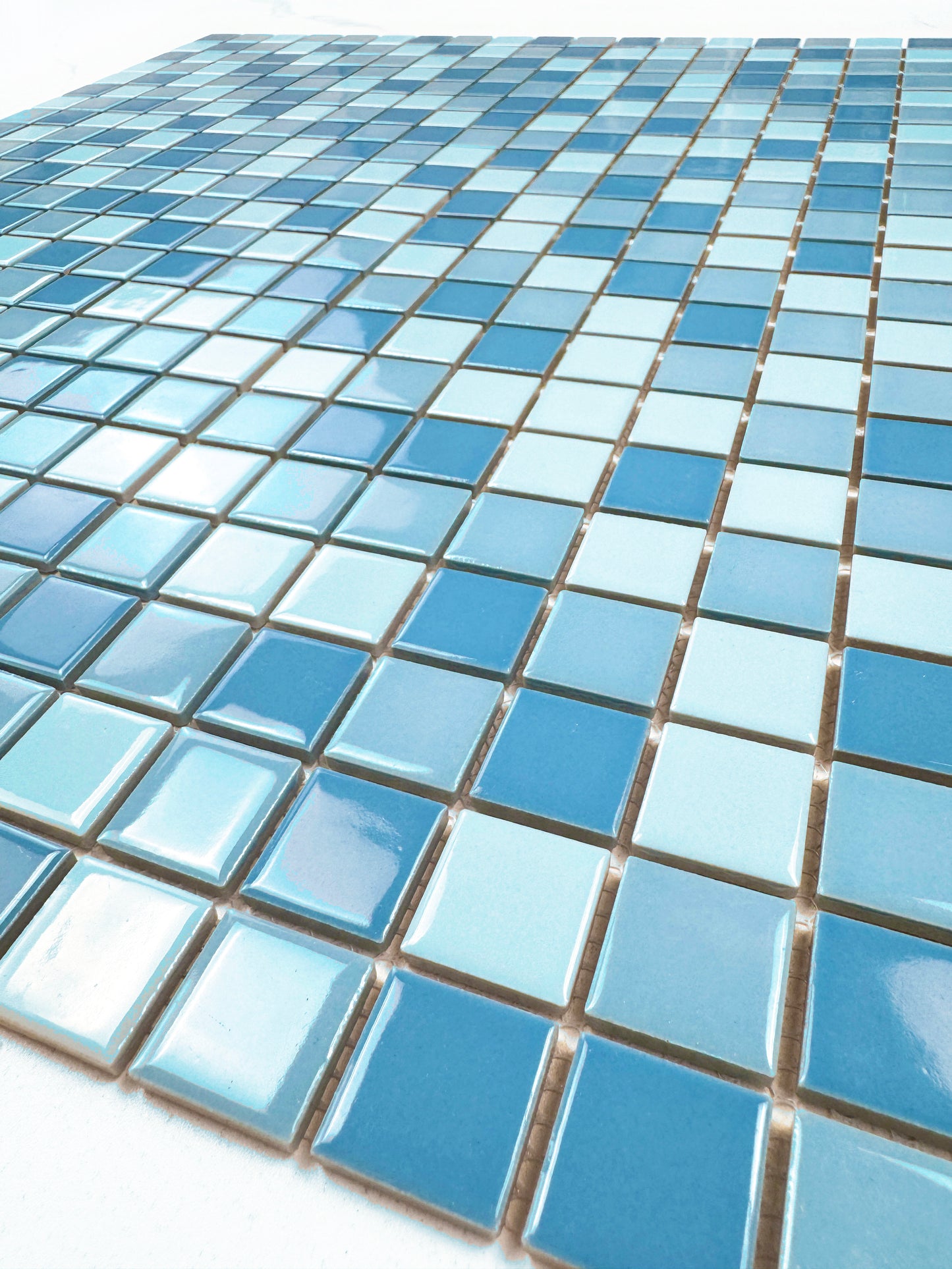 Close-up of blue mosaic tiles on a white background