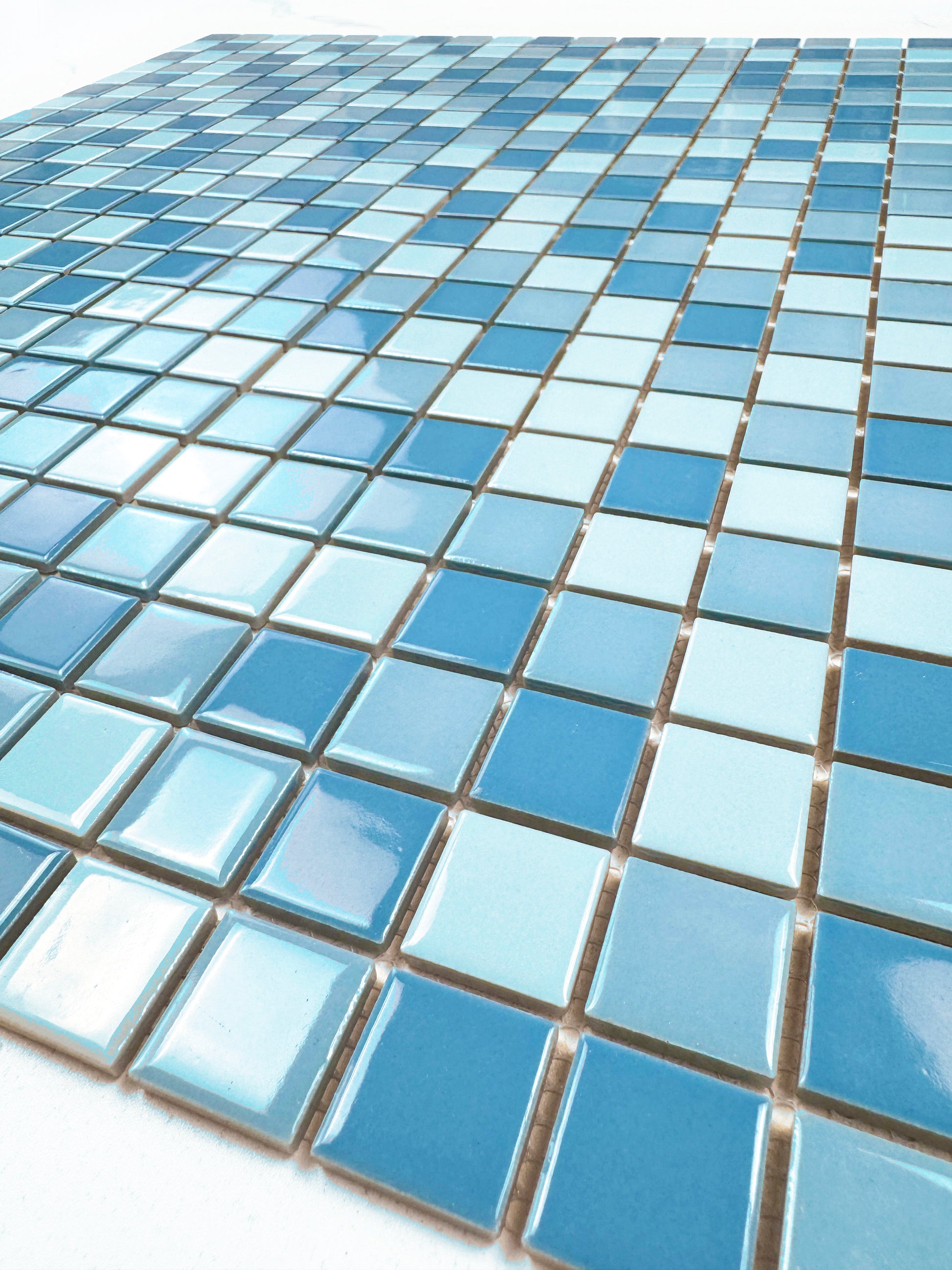 Close-up of blue mosaic tiles on a white background