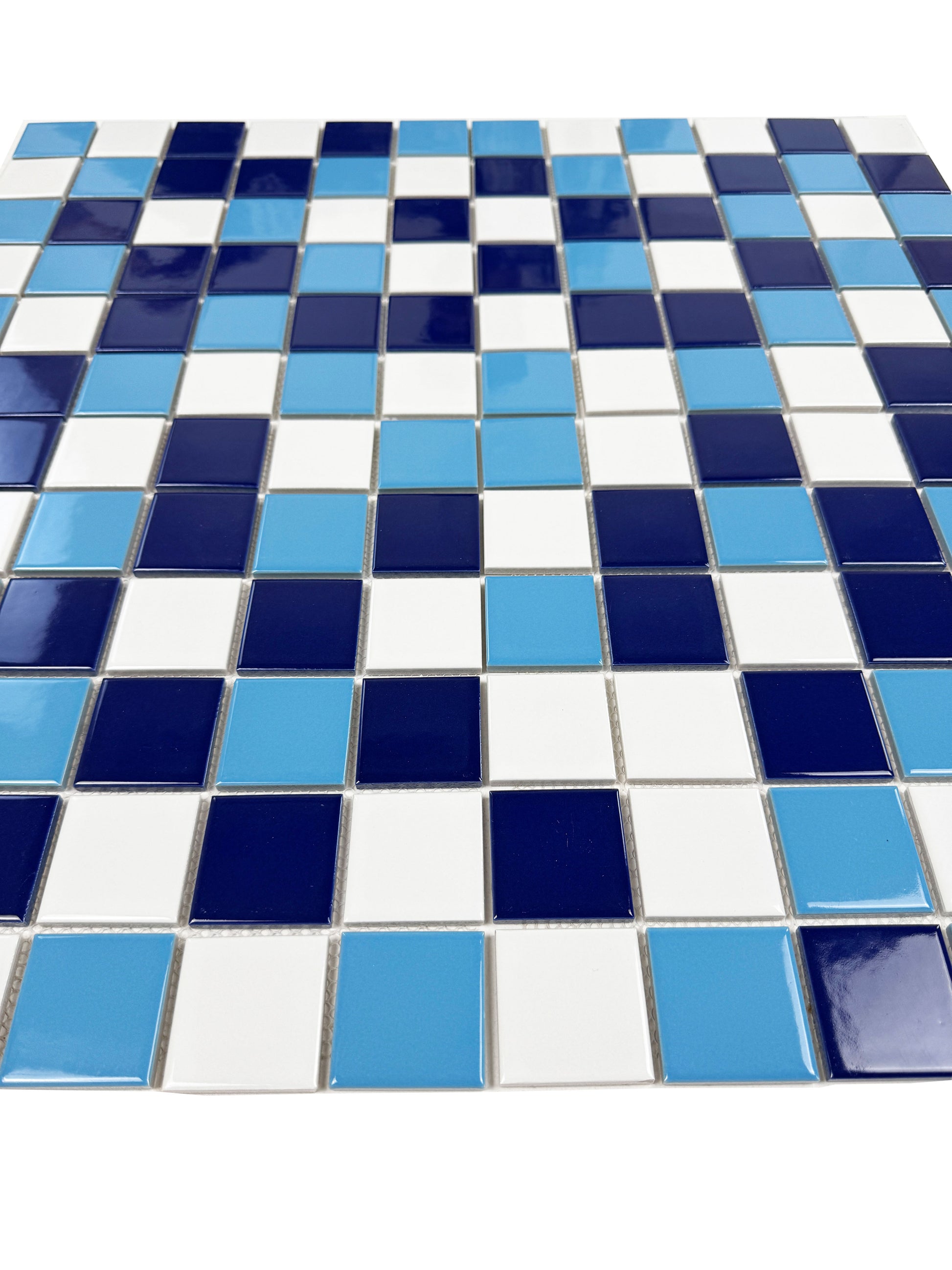 Mosaic pattern of blue, white, and navy tiles on a white background
