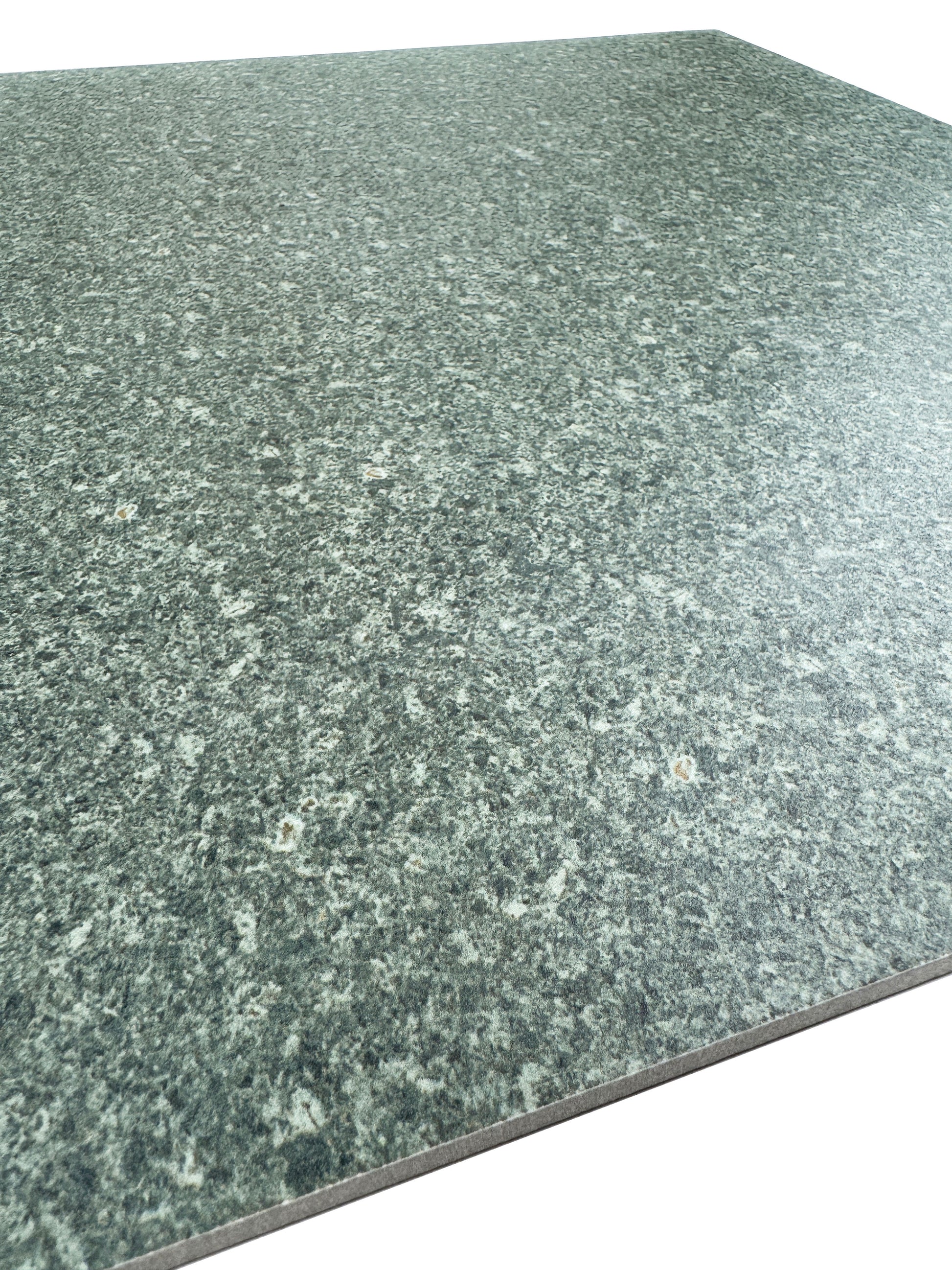 Green sukabumi porcelain with a speckled pattern on a white background