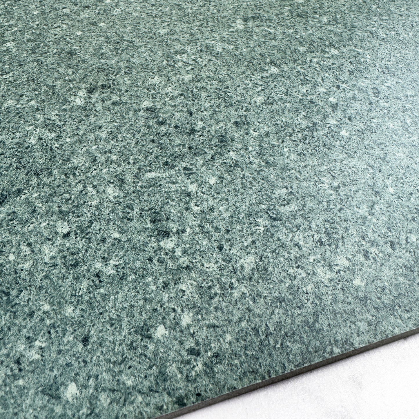 Close-up of a greenish-gray speckled material